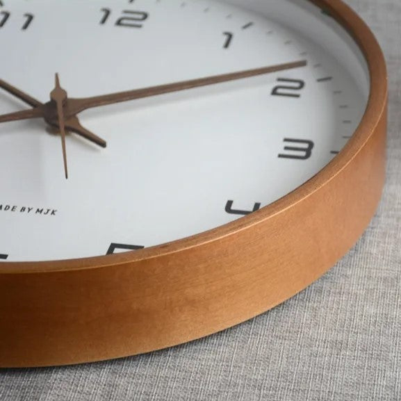 Timeless minimalist wall clock featuring a smooth wooden border