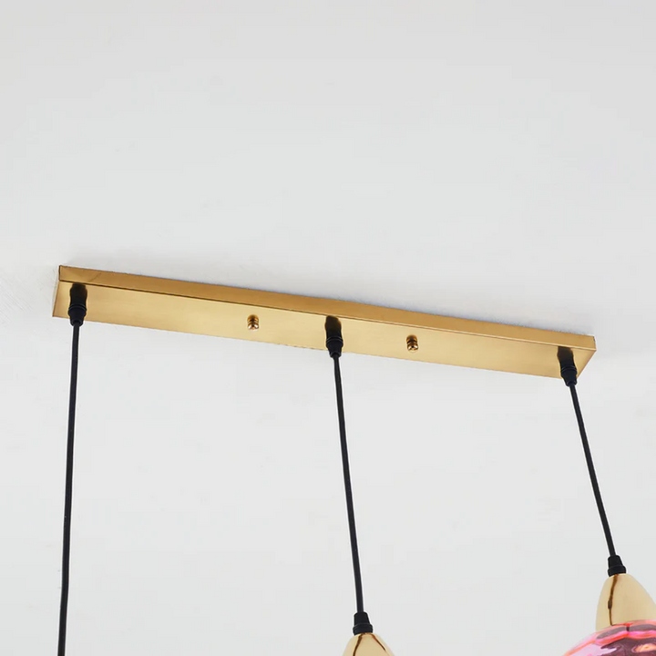 Adjustable LED cluster pendant lamp with three lights, ideal modern lighting for living rooms.