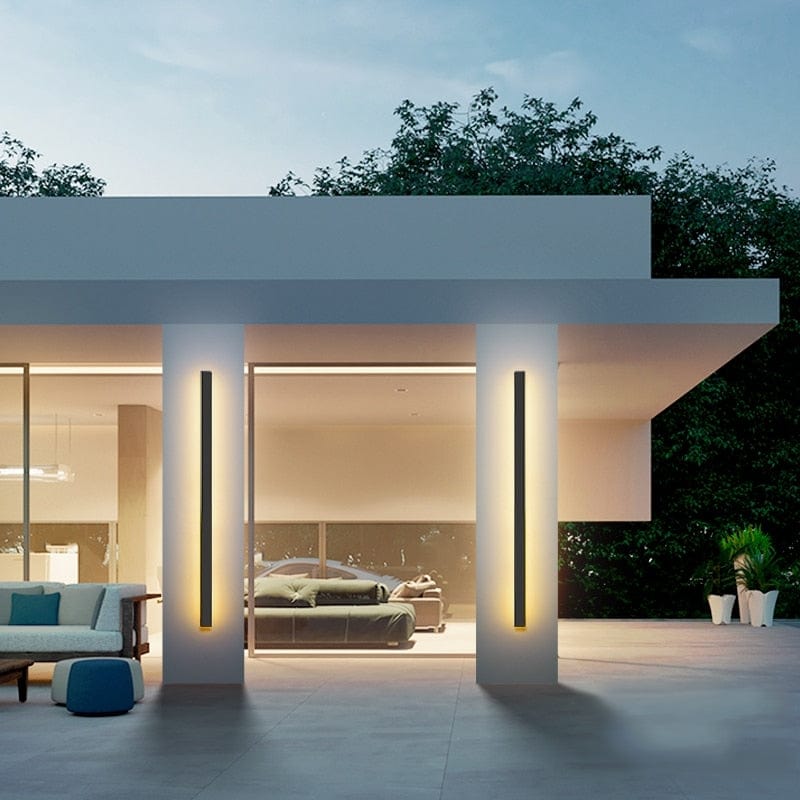 Sleek contemporary wall sconce on a modern house exterior, day view.