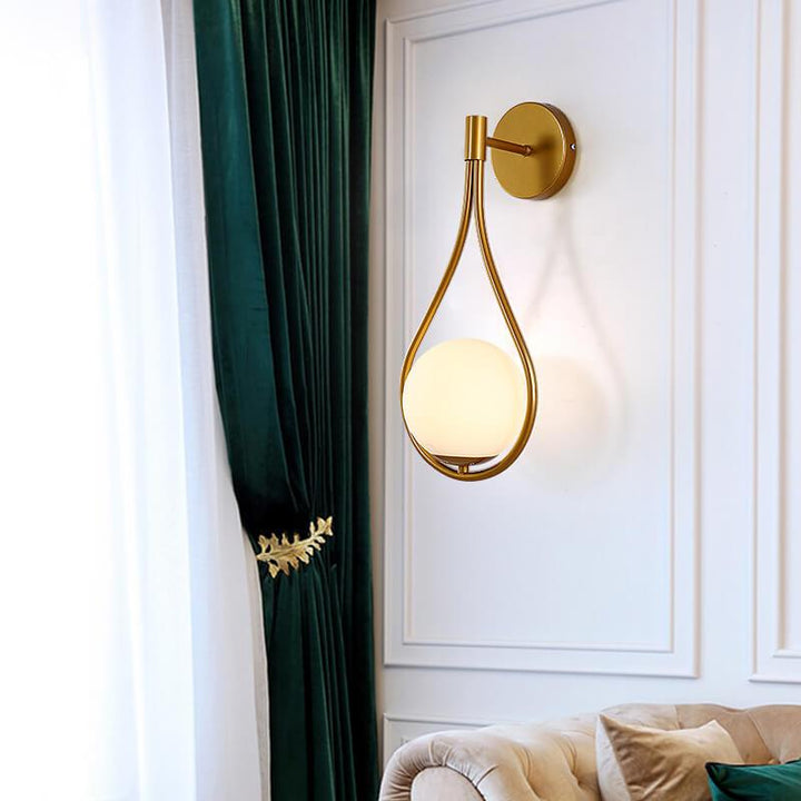 Modern black and gold LED globe wall sconce light fixture.