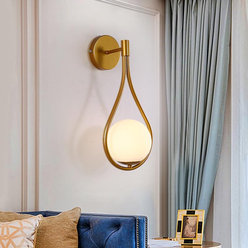 Contemporary black and gold globe sconce, energy-efficient LED lighting.