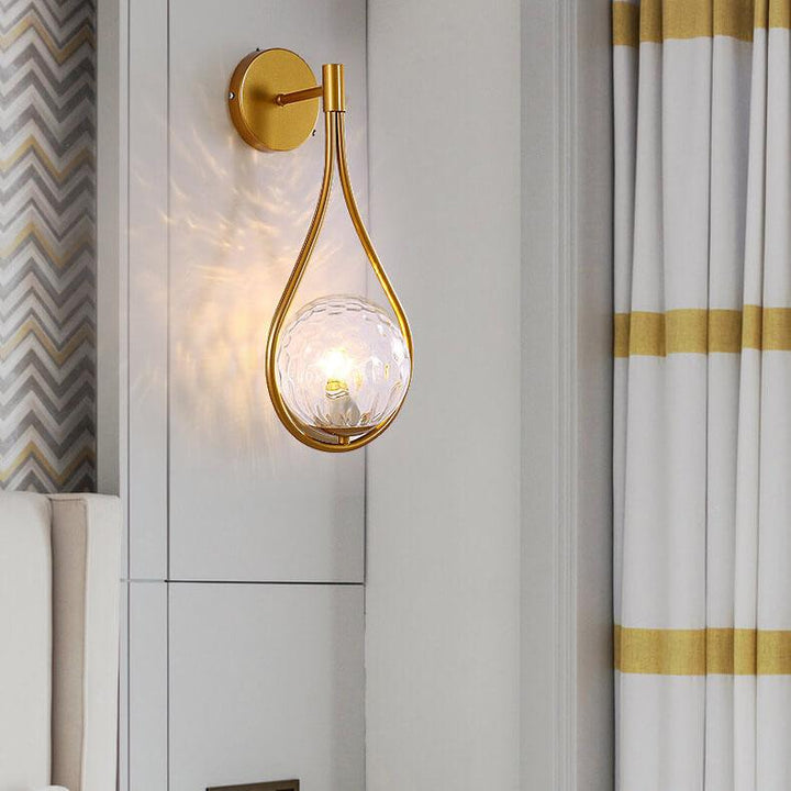 Elegant LED wall lamp featuring a black arm and gold globe shade.