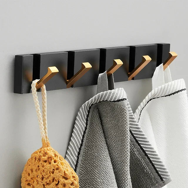 Sleek black & gold foldable wall hook, a minimalist addition to any organized space.