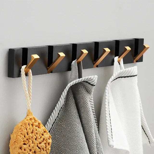 Modern foldable wall hook for entryway. Provides neat storage and saves space with black & gold finish.