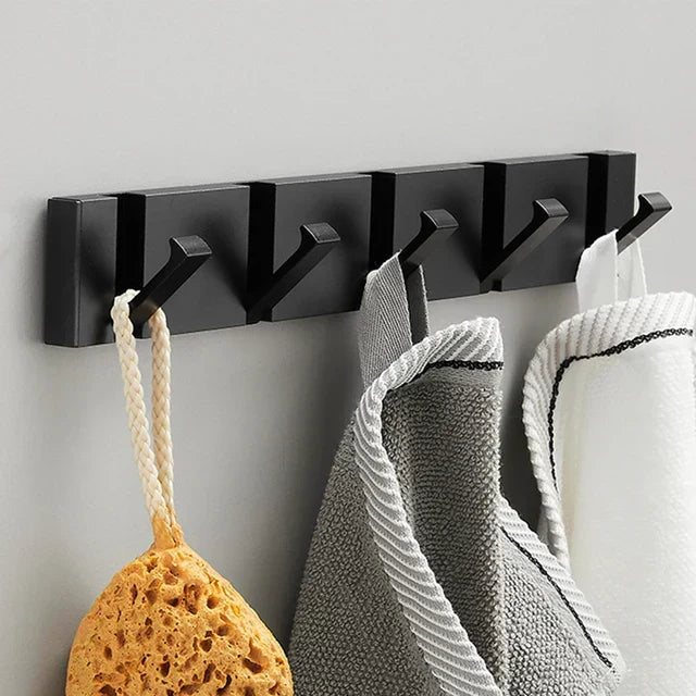Smart space-saving wall hook in black & gold, perfect for coats and hats in a modern entryway.