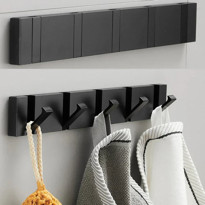 Contemporary foldable coat hook, black & gold finish, ideal for space-saving home organization.