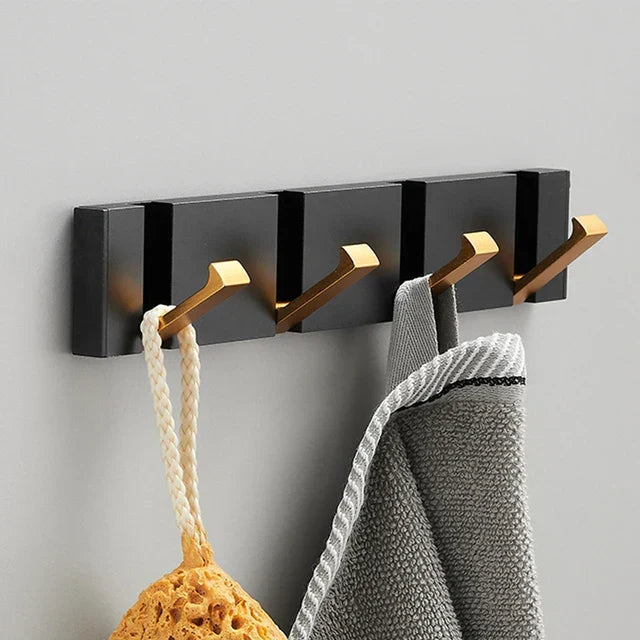 Functional foldable wall hook for modern homes. Space-saving solution in black & gold.