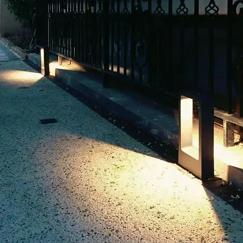 Stylish modern exterior lawn lamp, a black LED light for garden and landscape lighting.