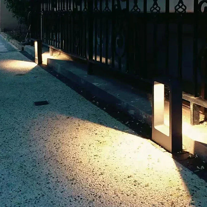 Stylish modern exterior lawn lamp, a black LED light for garden and landscape lighting.