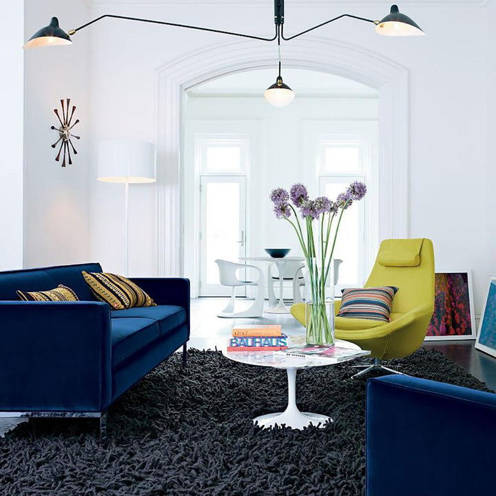 Modern black multi-arm lamp, adjustable, dynamic light for contemporary home.