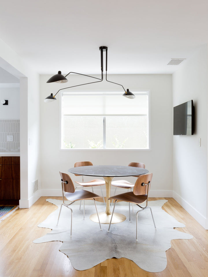 Dynamic black multi-arm ceiling light, adjustable for perfect illumination.