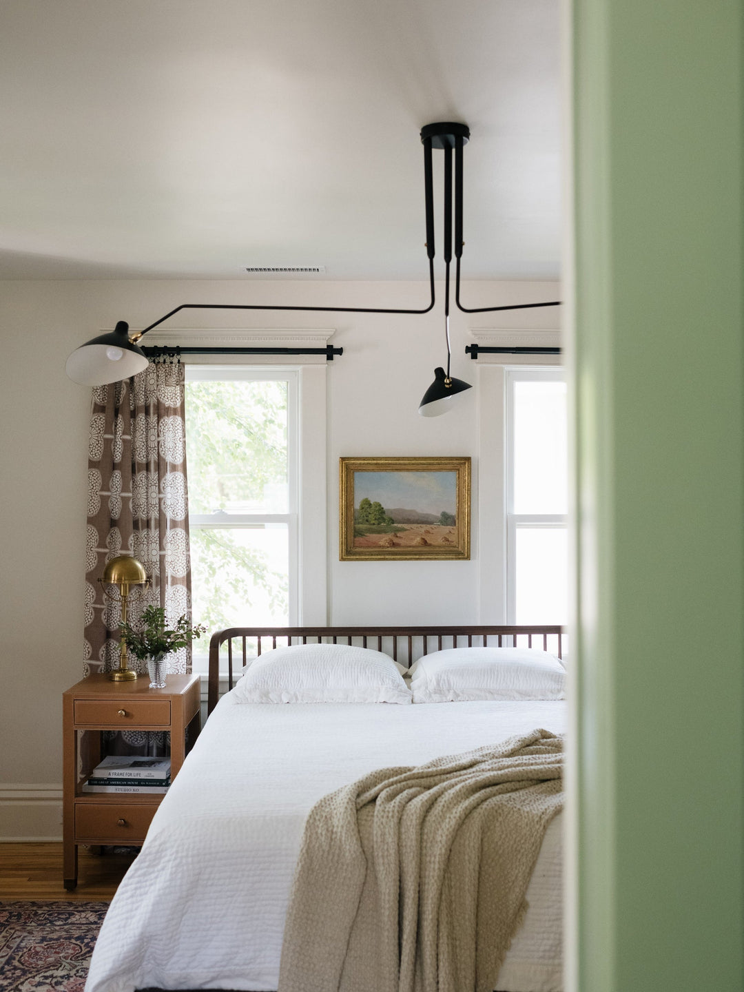 Adjustable white multi-arm minimalist lamp, enhances modern interiors.