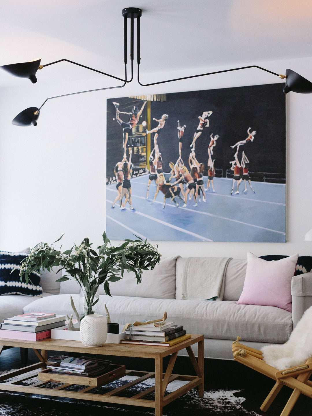 Adjustable black multi-arm ceiling lamp, minimalist and functional.