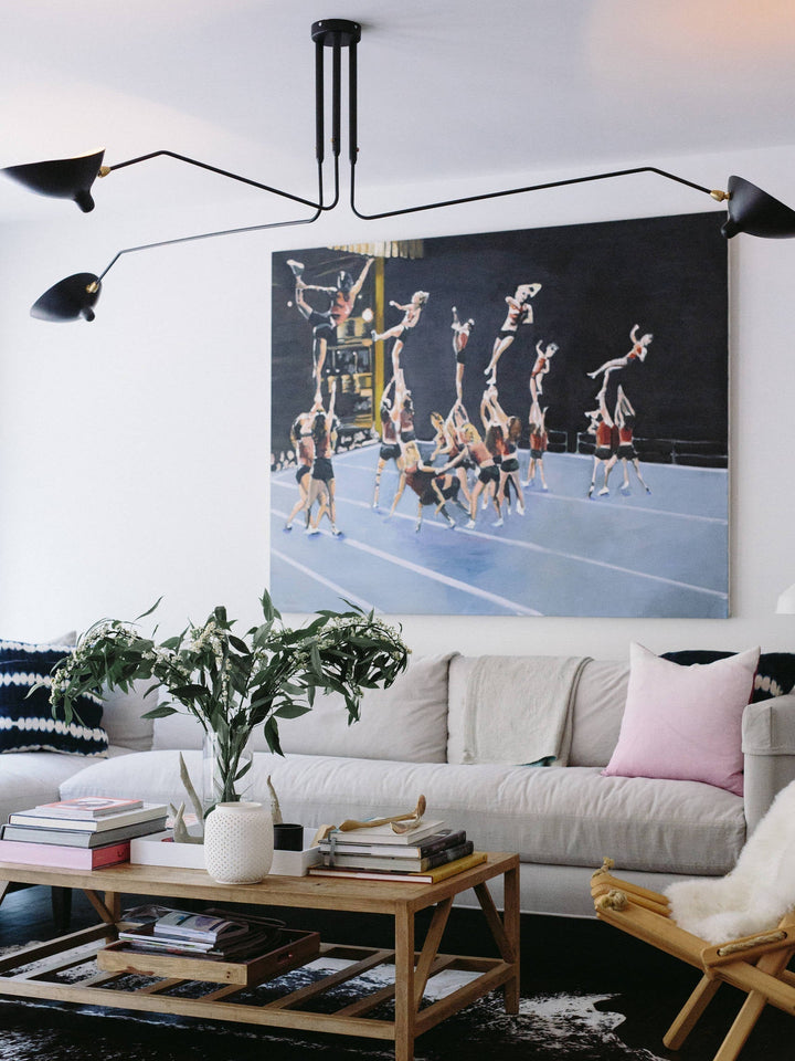 Adjustable black multi-arm ceiling lamp, minimalist and functional.