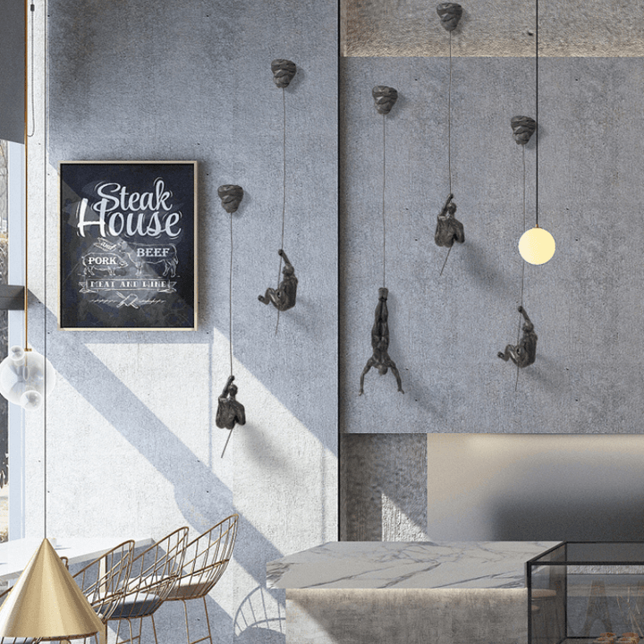 Modern wall sculpture set of climbing men, perfect for living room accent.
