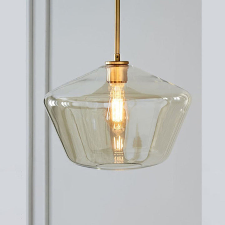 Sleek diamond pendant light with clear glass shade for a modern dining space.