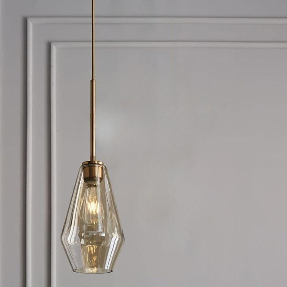 Adjustable diamond-shaped glass pendant light, a focal point for modern interiors.