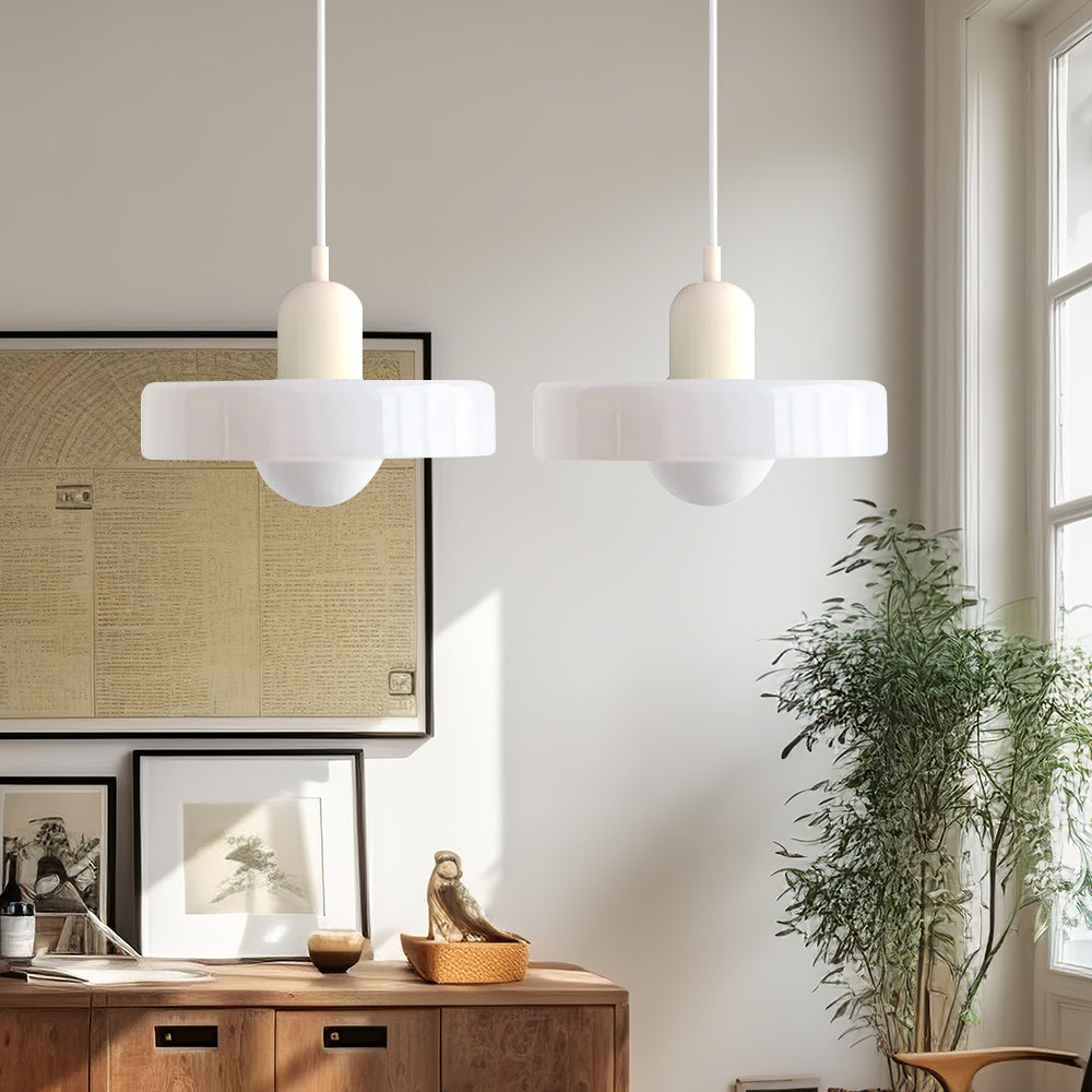 Sleek double glass pendant fixture, offering ambient light to dining areas.