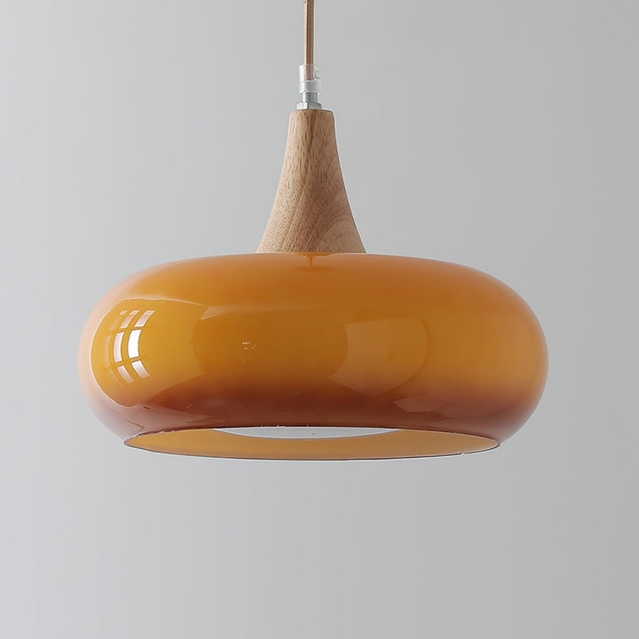 Sophisticated glass pendant lamp, modern lighting with wood details for upscale living.