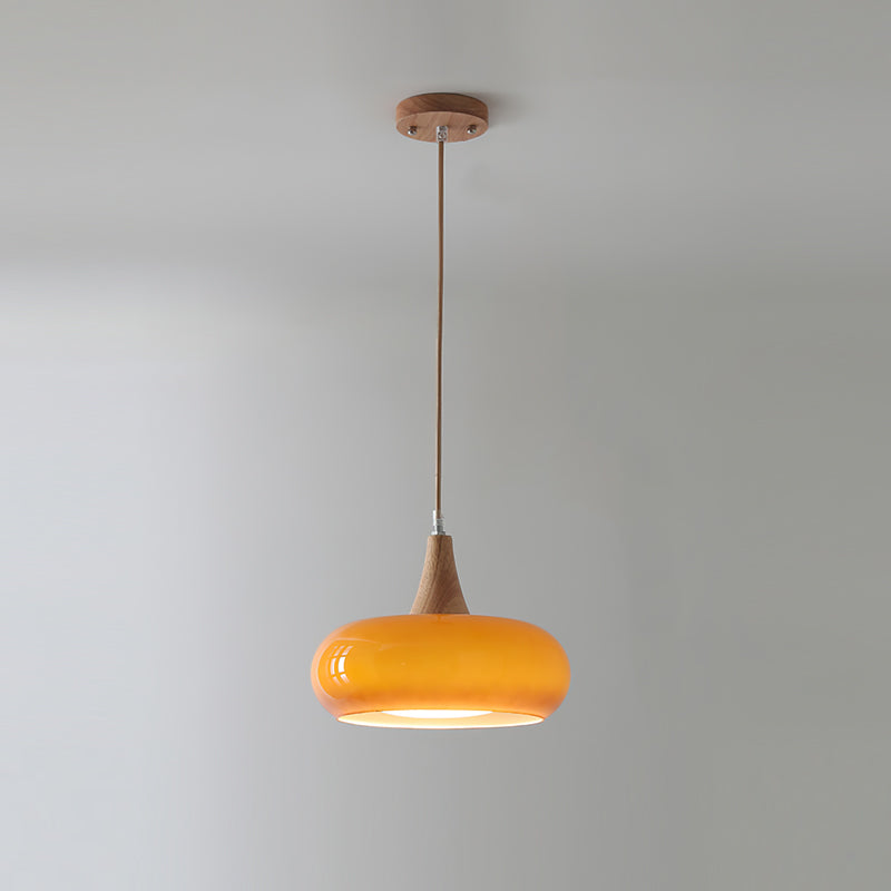 Handcrafted modern glass pendant light with wood accents, perfect for contemporary homes.