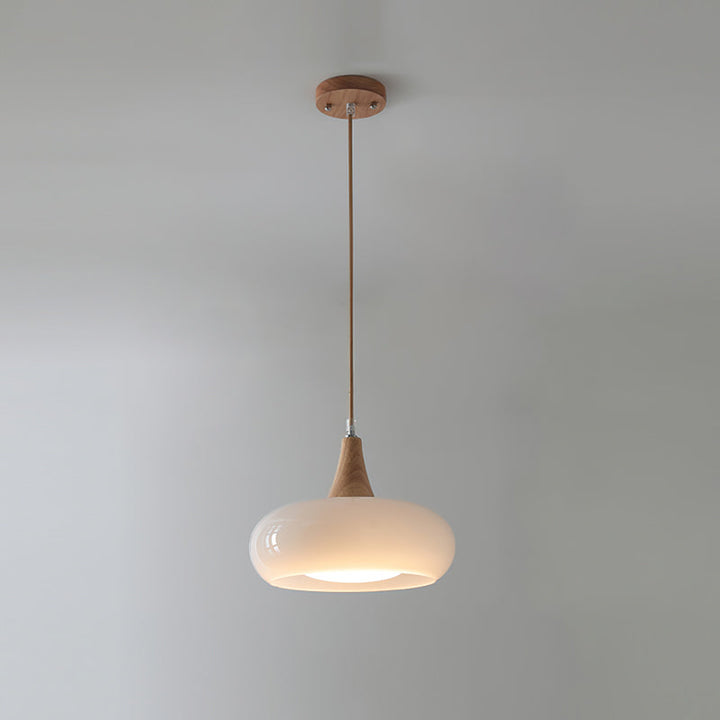 Architectural modern glass pendant light with wood, perfect for dining room statement.