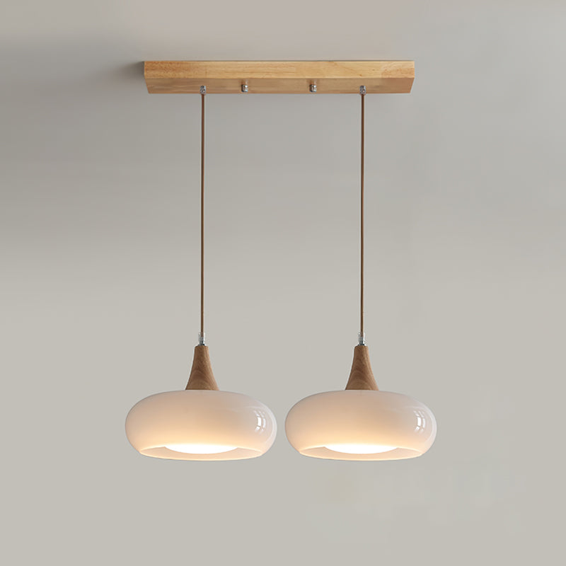 Modern glass pendant light, a sophisticated home decor choice with wood elements.