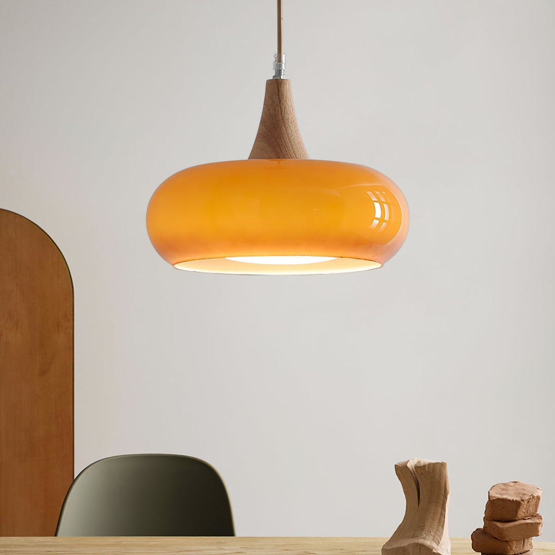 Sleek modern glass pendant light for dining room, featuring sophisticated wood accents.