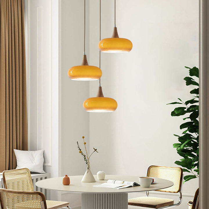 Stylish modern glass ceiling light with wood elements for dining & kitchen areas.
