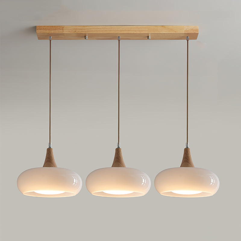 Chic glass pendant lamp with wooden top, enhancing modern living room decor.