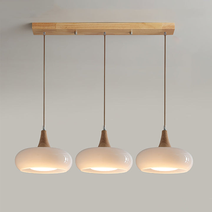 Chic glass pendant lamp with wooden top, enhancing modern living room decor.