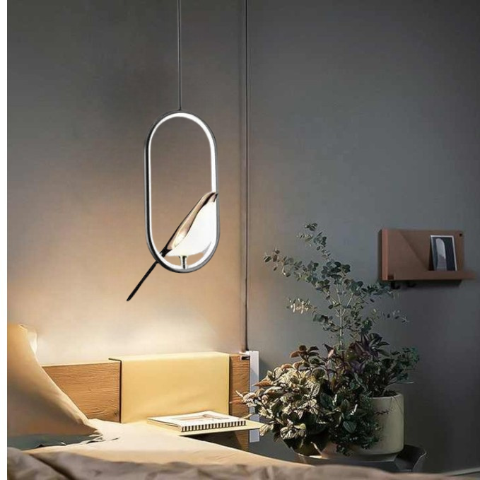 Modern decorative golden bird pendant light. Elegant ceiling fixture for sophisticated home lighting.