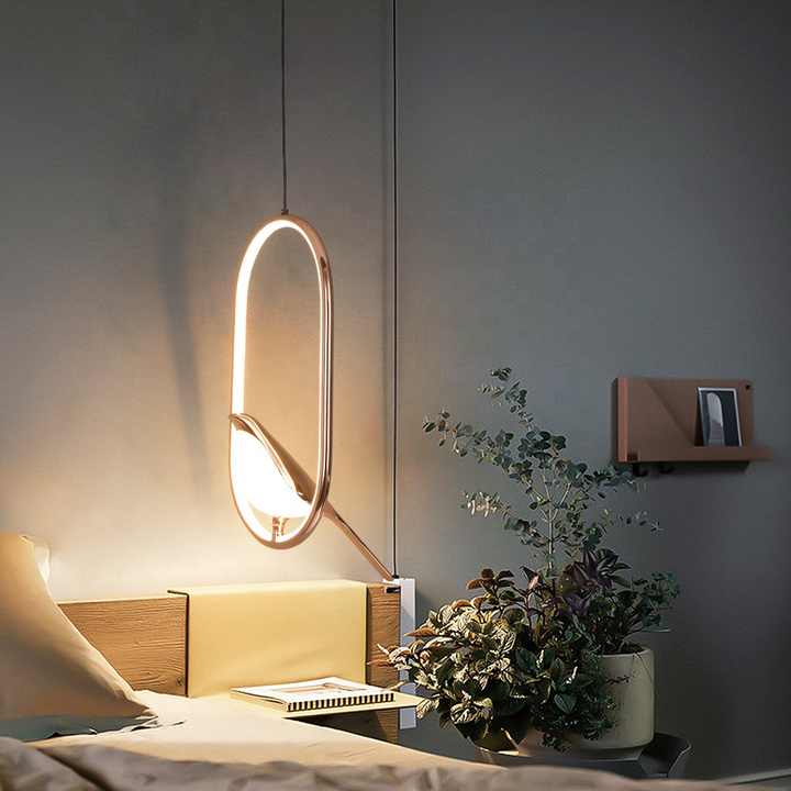 Sleek modern pendant light with golden bird design. Contemporary ceiling fixture for stylish home decor.