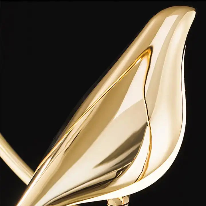 Decorative pendant light featuring a golden bird. A modern ceiling lamp for elegant interior lighting.