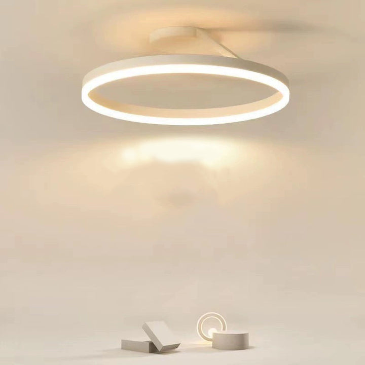 Modern LED ceiling lamp, sleek design enhances living room ambiance.