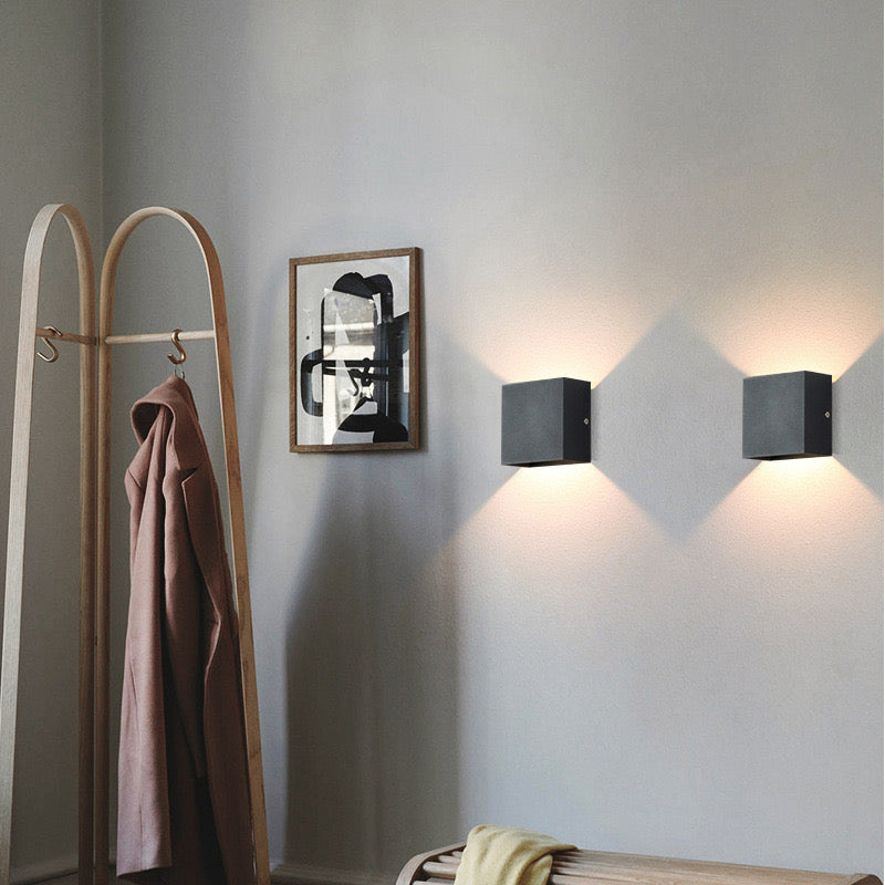 Outdoor LED wall lamp, adjustable direction, square shape, provides focused illumination for security.