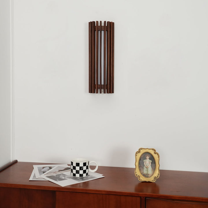 Minimalist indoor wall lamp, wood trim & white acrylic diffuser, brightens modern spaces.