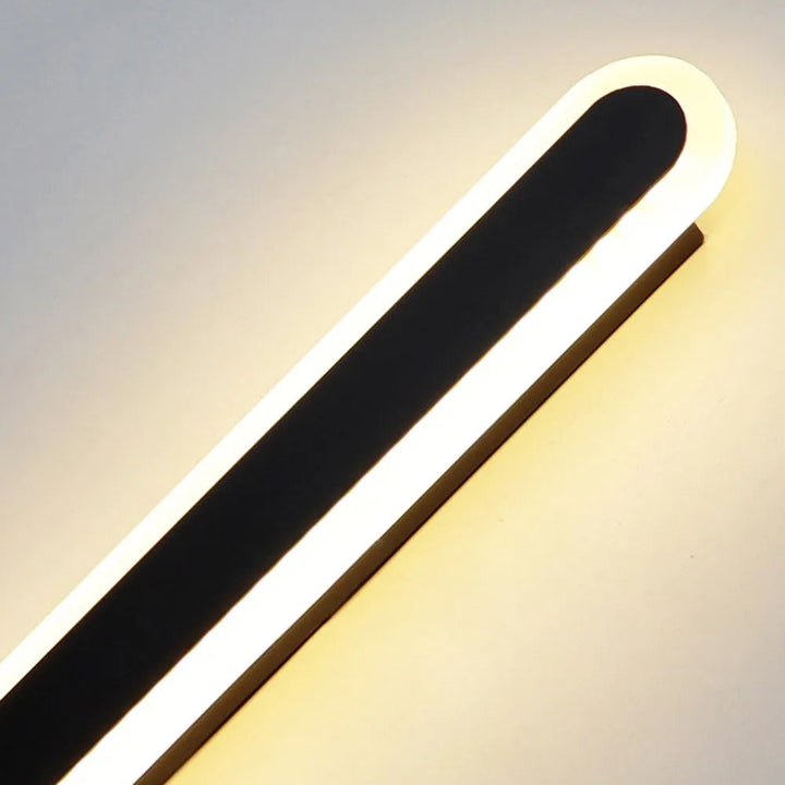 Modern linear LED outdoor wall lamp, black finish, sleek exterior light fixture.