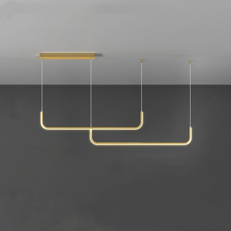 Modern linear LED pendant light above a long dining table, creating perfect ambiance for gatherings.