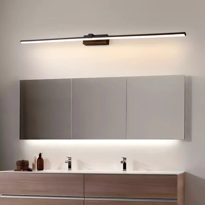 Sleek gold finish linear LED bathroom light, contemporary and hardwired.