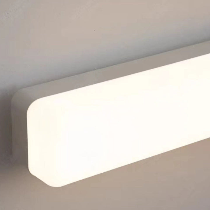 Elegant linear LED wall sconce, provides bright ambient light for bathroom vanity areas.