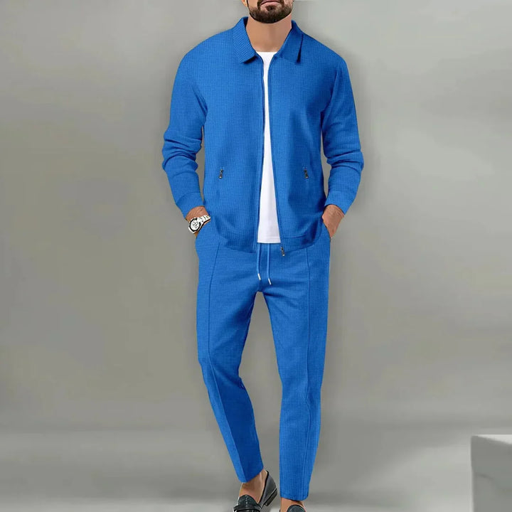 Sharp men's slim fit two-piece suit. Features a tailored blazer & matching trousers, ideal for formal & business occasions.