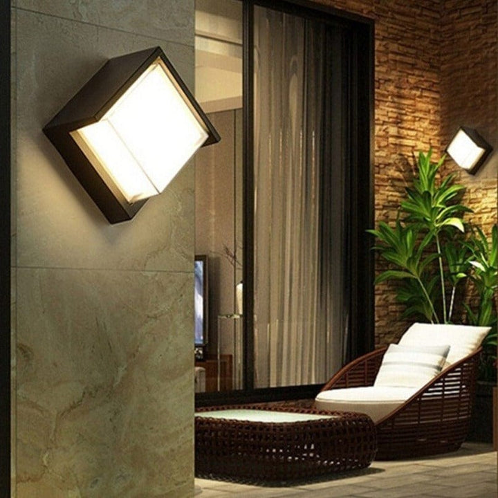 Sleek black modern outdoor wall light with motion sensor. LED weatherproof security lamp for entryways.