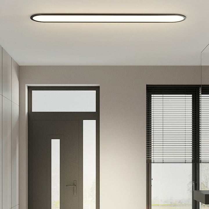 Bedroom modern oval LED flush mount ceiling light, sleek profile, offers soft, ambient glow.