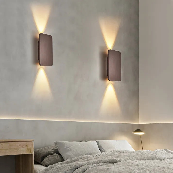 Sleek black LED wall light, up-down lighting, enhances modern interior design.