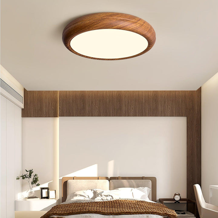 Contemporary round LED ceiling fixture, dimmable, for a modern interior space.