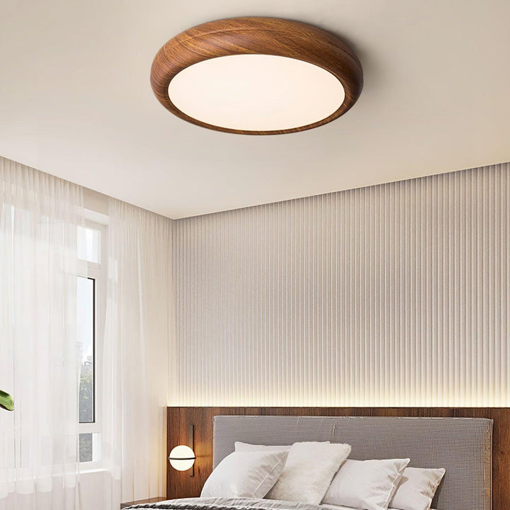 Contemporary wood grain round LED flush mount, sleek design for modern homes.