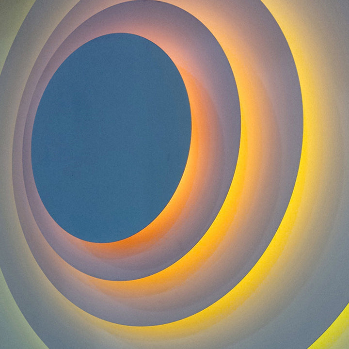 Yellow modern round LED wall light, bright accent lighting for home interiors.