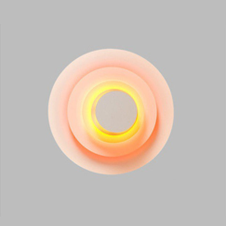 Decorative modern round LED wall light, enhancing any indoor space with vibrant color.
