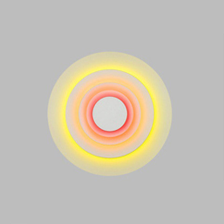 Pink modern round LED indoor wall light, stylish & vibrant for bedrooms and living areas.