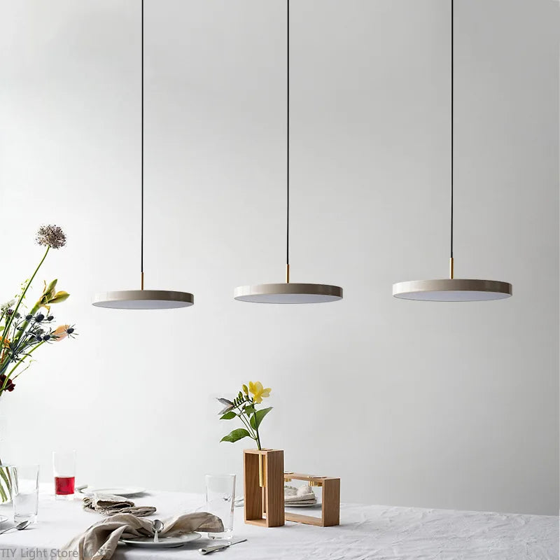 Scandinavian pendant lamp illuminating a dining room with warm ambient light.